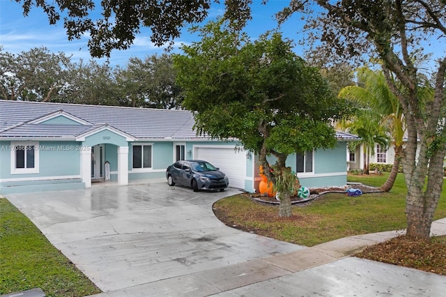 ranch-style house with a garage and a front yard