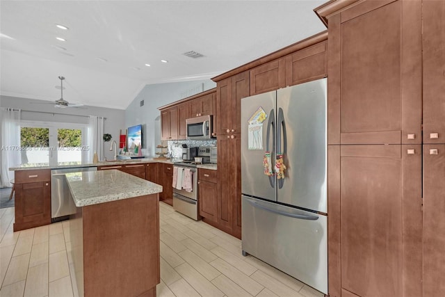 kitchen with a kitchen island, lofted ceiling, sink, kitchen peninsula, and stainless steel appliances