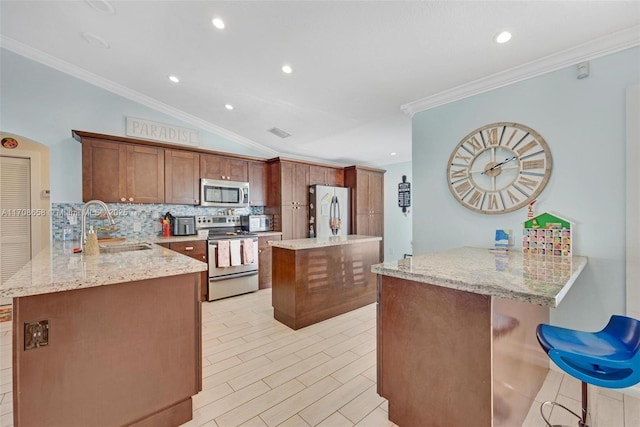 12921 SW 17th Ct, Miramar, FL 33027 - kitchen featuring stainless steel appliances, a sink, tasteful backsplash, a peninsula, and light stone counters