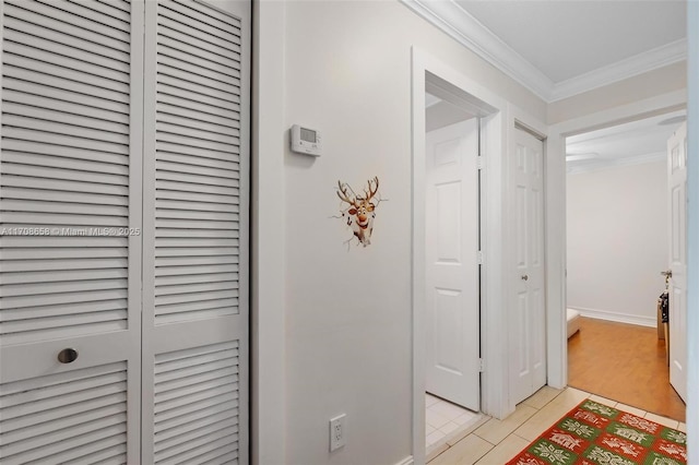 hall with crown molding and light hardwood / wood-style flooring