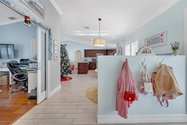 mudroom with crown molding, vaulted ceiling, and light wood-type flooring