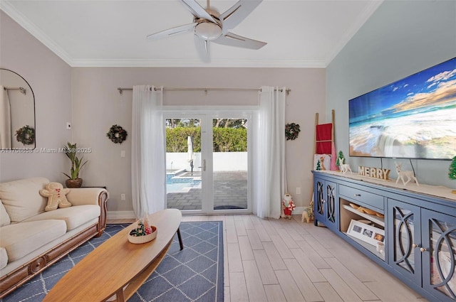 living room featuring ceiling fan, ornamental molding, and wood-type flooring