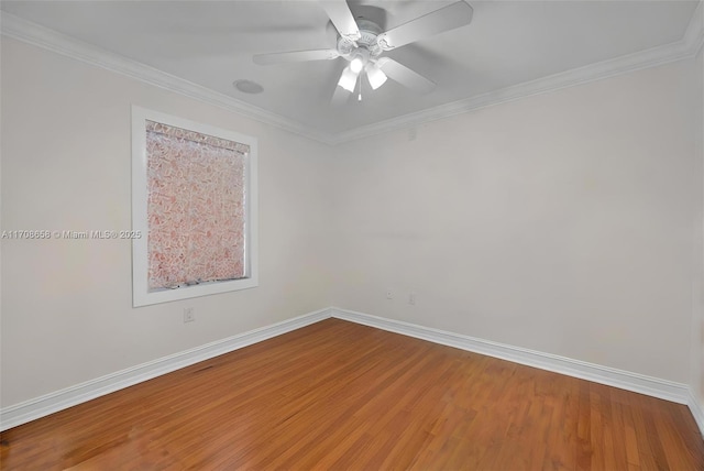 empty room featuring hardwood / wood-style flooring, crown molding, and ceiling fan