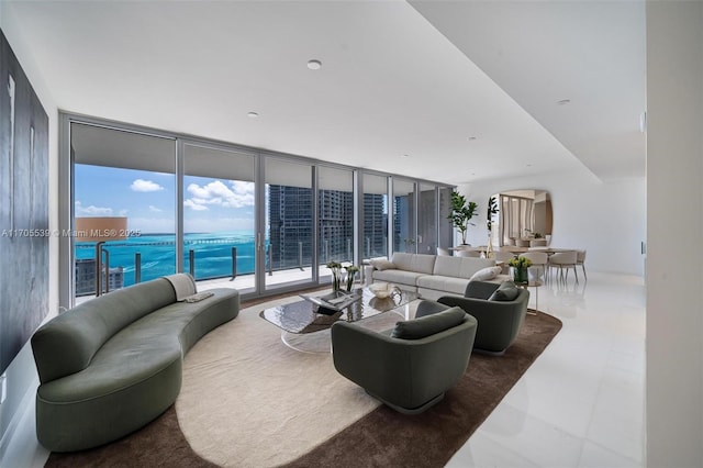 living room with floor to ceiling windows and a water view