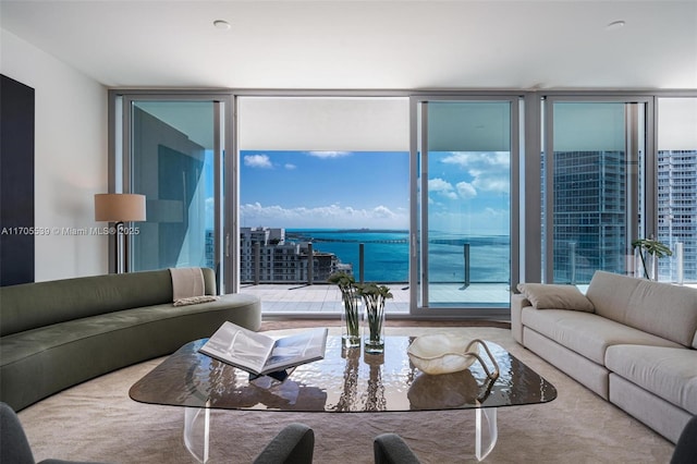 living room with expansive windows and a water view