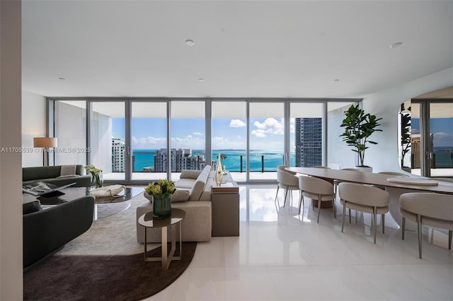 living room with floor to ceiling windows and a water view