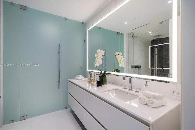 bathroom with vanity and a shower with shower door