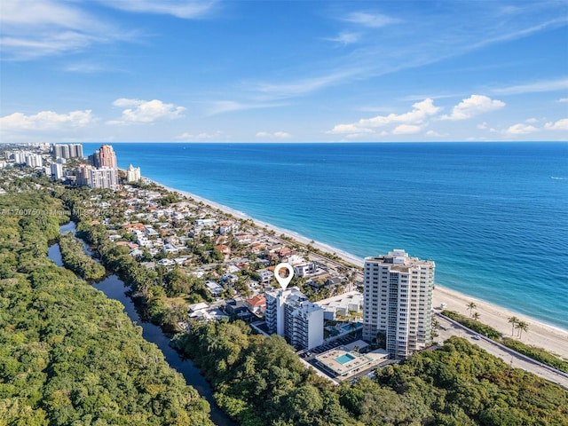 drone / aerial view with a beach view and a water view