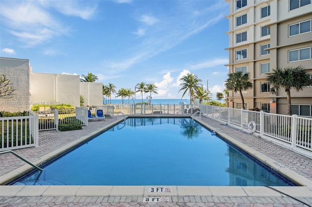 view of pool featuring a water view