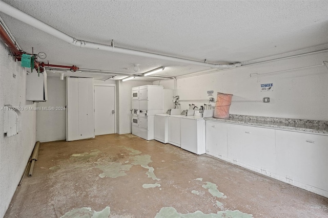 garage featuring washer and clothes dryer and stacked washer and clothes dryer