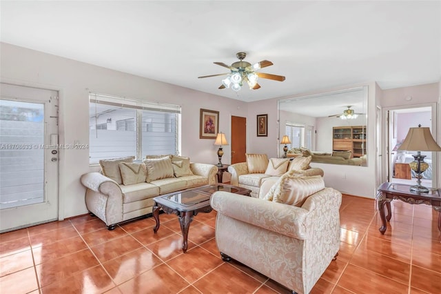 living room with ceiling fan, tile patterned flooring, and a healthy amount of sunlight