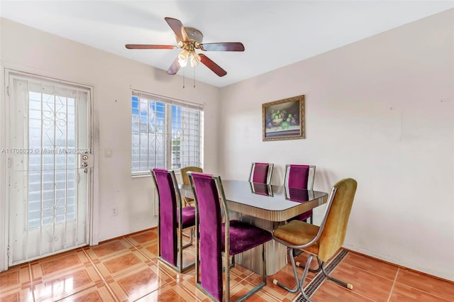 dining area with light tile patterned floors, a wealth of natural light, and ceiling fan