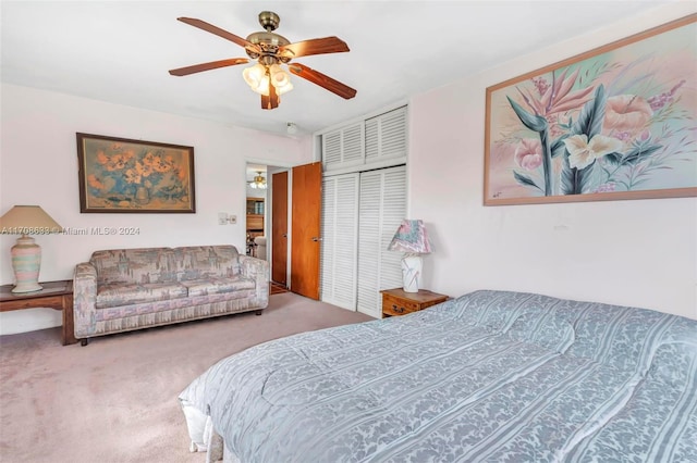 carpeted bedroom featuring a closet and ceiling fan