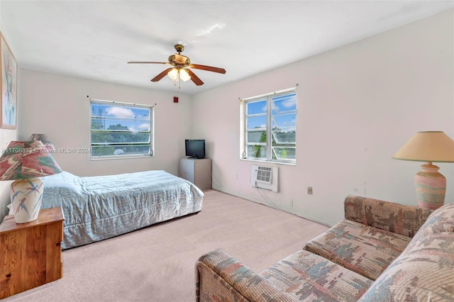 carpeted bedroom with ceiling fan and an AC wall unit