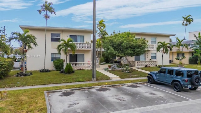 2072 NE 169th St Unit 10, North Miami Beach, FL 33162 - multi unit property featuring uncovered parking, stucco siding, and a front lawn