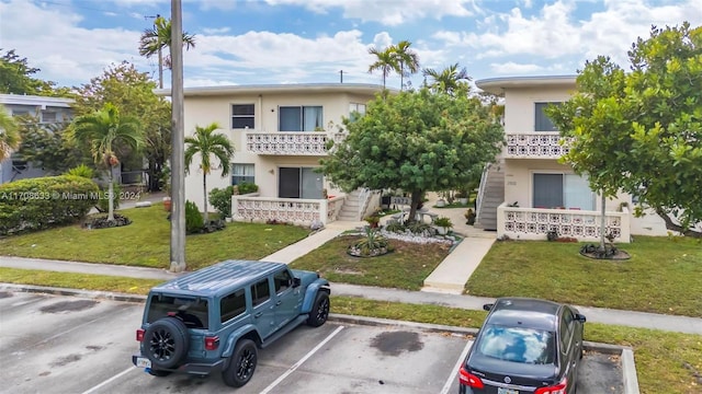 2072 NE 169th St Unit 10, North Miami Beach, FL 33162 - townhome / multi-family property with uncovered parking, stucco siding, and a front yard