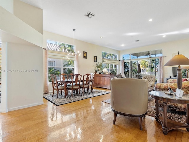 living room featuring light hardwood / wood-style floors and a chandelier