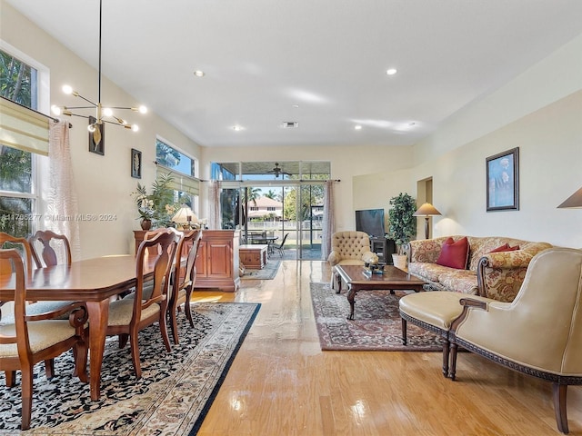 dining area with a chandelier and light hardwood / wood-style flooring