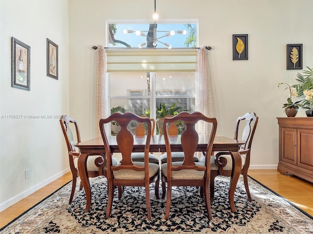 dining area with a chandelier and light hardwood / wood-style floors