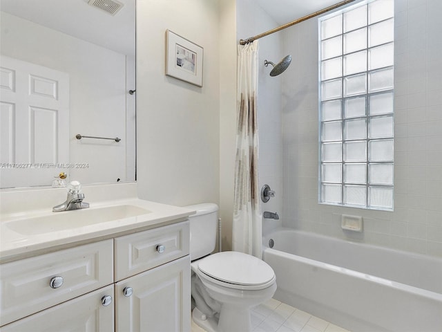 full bathroom featuring shower / bath combo with shower curtain, tile patterned flooring, vanity, and toilet