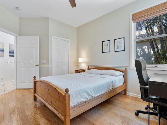 bedroom featuring ceiling fan, a closet, and light hardwood / wood-style flooring