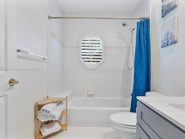 full bathroom featuring tile patterned flooring, vanity, toilet, and shower / tub combo with curtain