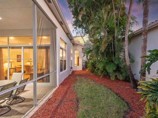 yard at dusk featuring a patio area