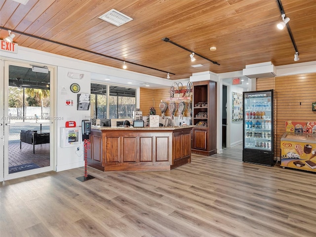 kitchen featuring light wood-type flooring, wooden ceiling, and a healthy amount of sunlight