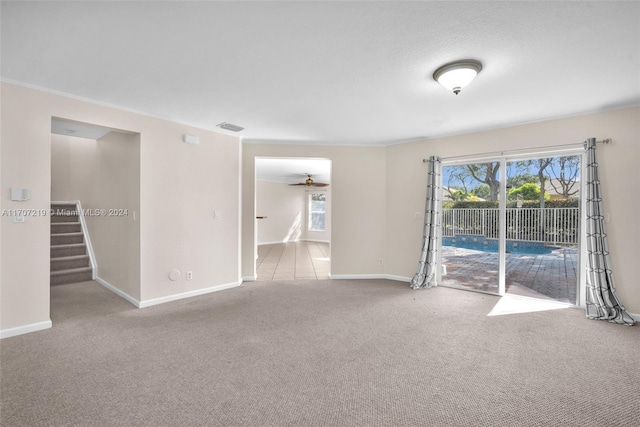 carpeted empty room featuring ceiling fan