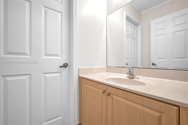 bathroom featuring vanity and ornamental molding