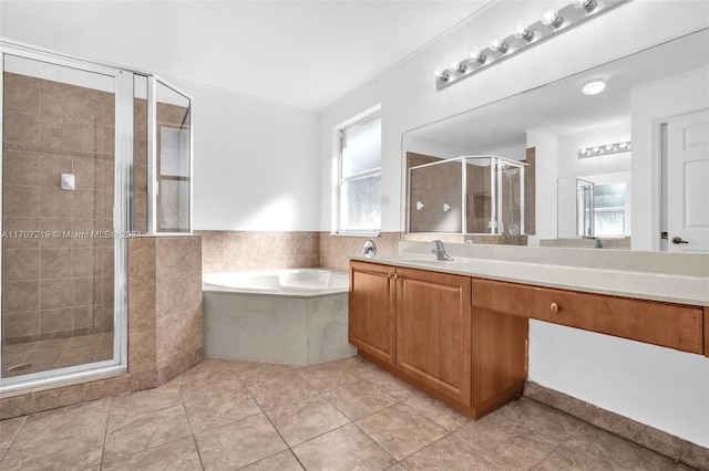 bathroom with tile patterned floors, separate shower and tub, and vanity