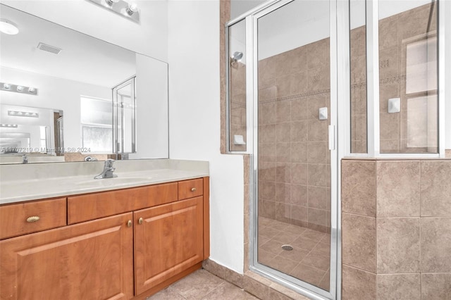 bathroom featuring tile patterned floors, vanity, and walk in shower