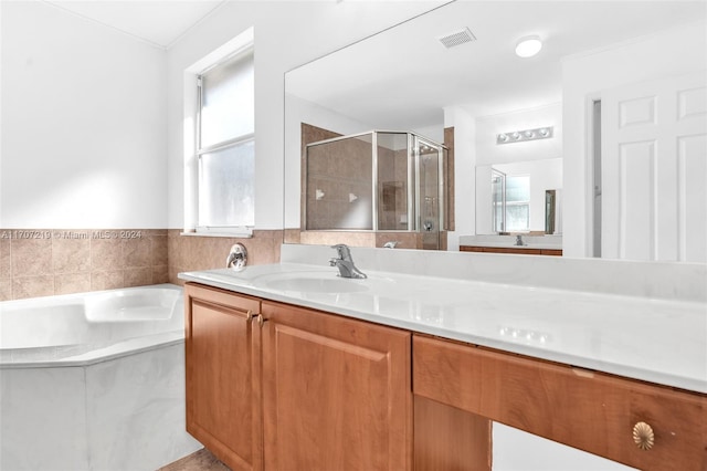 bathroom featuring separate shower and tub and vanity