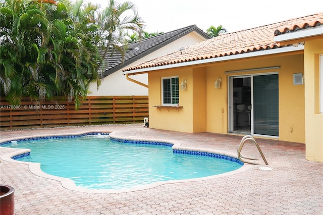 view of swimming pool with a patio area, a fenced in pool, and fence