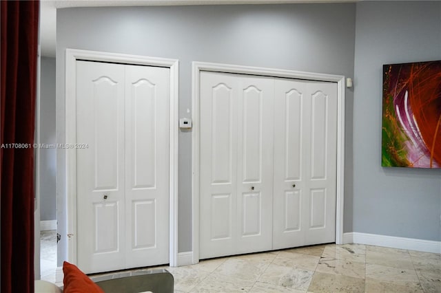 interior space featuring lofted ceiling and multiple closets