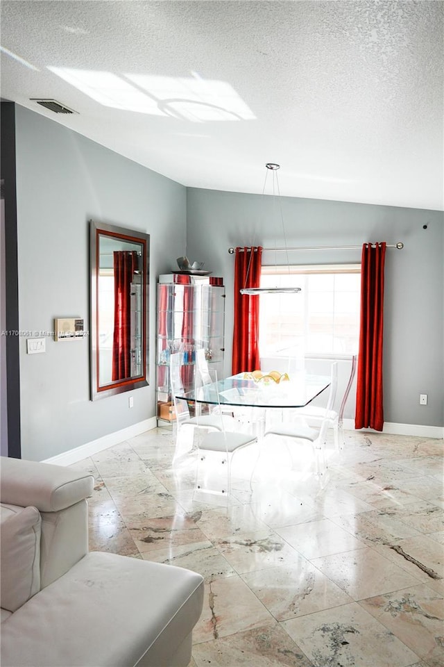 interior space featuring a textured ceiling and a wealth of natural light