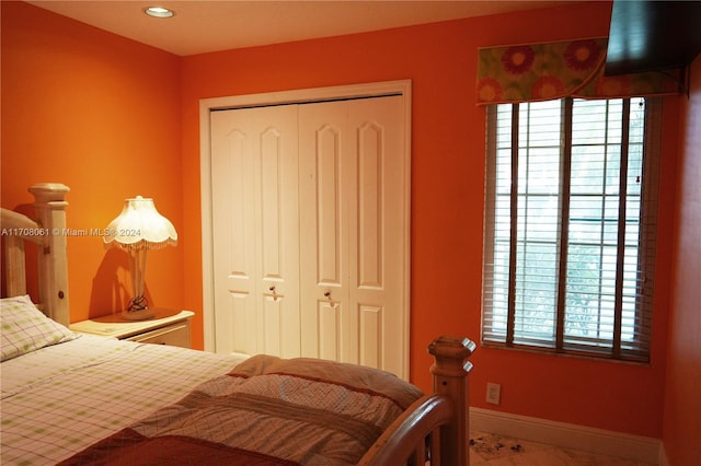 bedroom featuring a closet and multiple windows