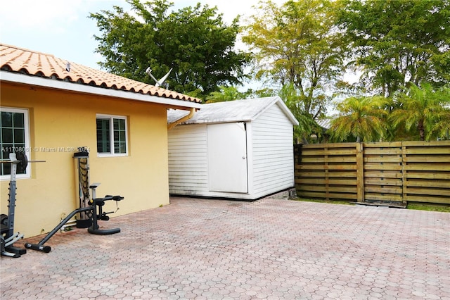 view of patio / terrace featuring a storage unit