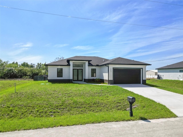 prairie-style home with concrete driveway, stucco siding, an attached garage, and a front yard