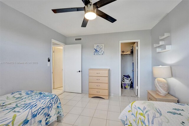 tiled living room featuring ceiling fan