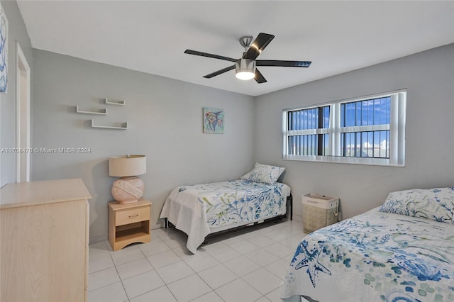 bedroom with ceiling fan and light tile patterned flooring