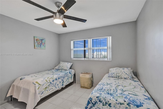 bedroom with ceiling fan and light tile patterned floors