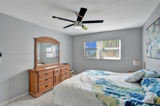 tiled bedroom with ceiling fan