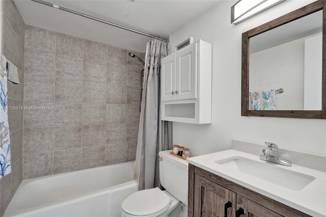 full bathroom with shower / tub combo with curtain, vanity, and toilet