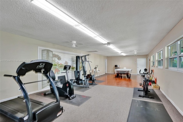 workout area with a textured ceiling and ceiling fan