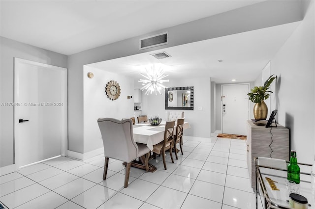 tiled dining room featuring a chandelier