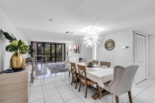 dining area featuring a chandelier and light tile patterned floors