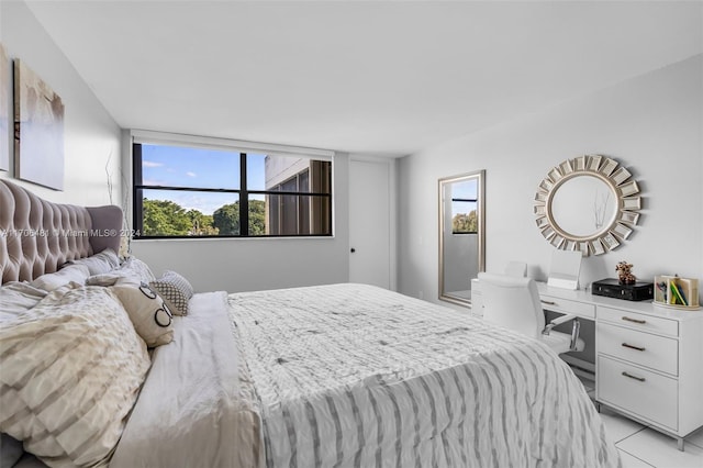 bedroom with light tile patterned floors and multiple windows