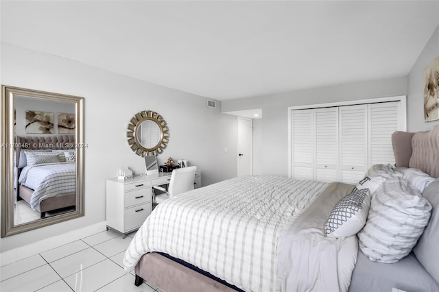 bedroom featuring light tile patterned floors and a closet
