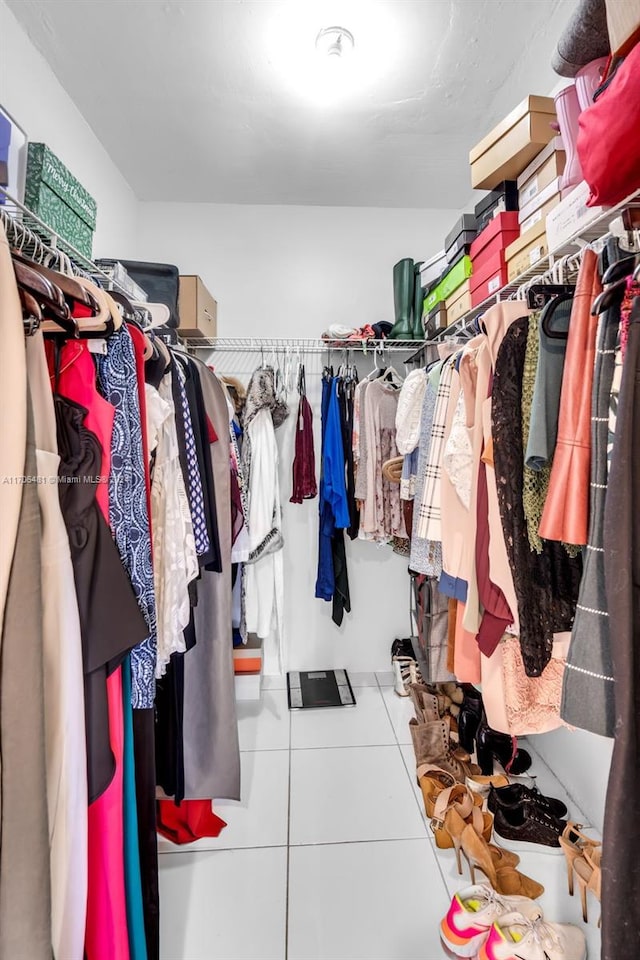 walk in closet with tile patterned floors